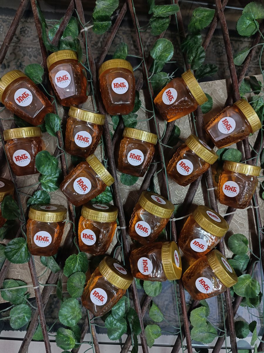 A tray of small HNB Foods honey jars